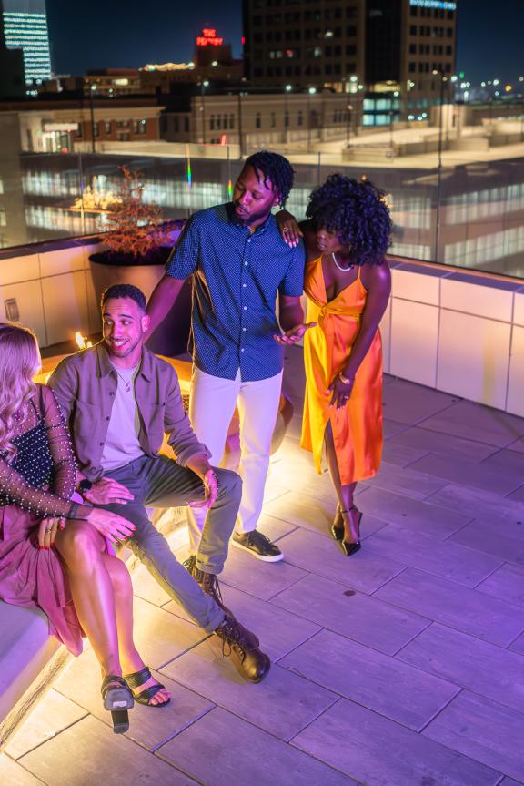 friends gathering around rooftop fire pit