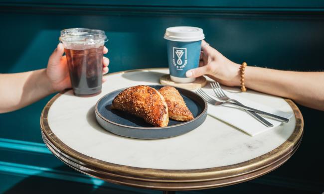 A table of coffee and breakfast from Hustle &amp; Dough at ARRIVE Hotel