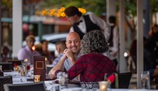man and woman dine on the patio of Porch &amp; Parlor