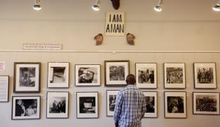 Man looking at photographs at the Withers Collection Museum &amp; Gallery.